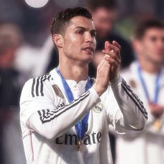 the soccer player is applauding his team's win in front of fans