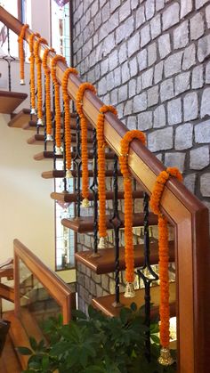 an orange garland is tied to the banister