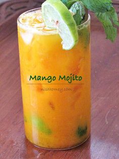 an orange drink with lime and mint garnish