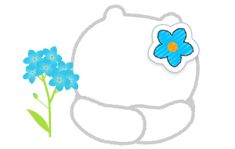 a white teddy bear with a blue flower