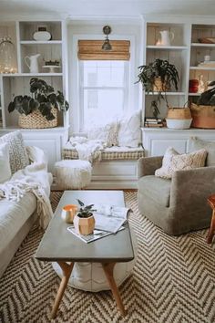 a living room filled with furniture and lots of plants in the window sills