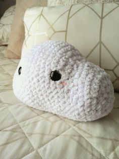 a crocheted stuffed animal laying on top of a bed