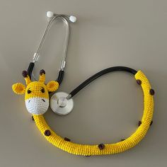 a knitted giraffe with a stethoscope attached to it's neck