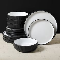 black and white dishes stacked on top of each other