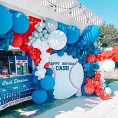 a baseball themed birthday party with balloons and streamers on the side of the building