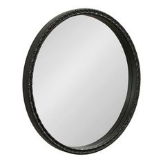 a round mirror with black frame and beading around the edges, on a white background