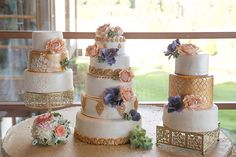 there are many different wedding cakes on the table