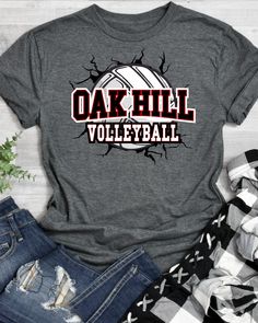 the oak hill volleyball t - shirt is shown next to ripped jeans