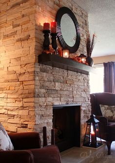 a living room filled with furniture and a fire place in front of a brick wall