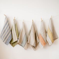 five folded towels hanging on a clothes line