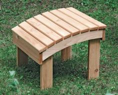 a wooden bench sitting on top of a lush green field