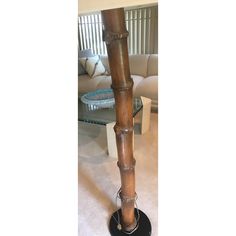 a tall wooden pole sitting in the middle of a living room