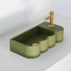 a green sink sitting on top of a white counter