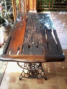 a wooden table sitting on top of a tiled floor