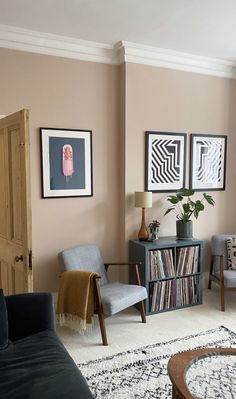 a living room filled with furniture and pictures on the wall