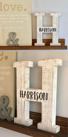 two wooden letters that are on top of a shelf in front of a wall with the words love and harrison