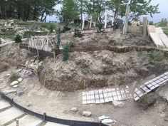 an aerial view of a construction site in the middle of trees and dirt, with stairs leading up to it