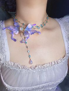 Immerse yourself in the realm of fantasy with our exquisite handcrafted fairy wing necklace. This stunning piece brings ethereal beauty to life, perfect for the dreamers and believers among us. ✨ Design Features: * Centerpiece: Large, intricately detailed fairy/butterfly wings * Wings Color: Mesmerizing blend of iridescent purple and blue with hints of teal * Material: High-quality resin with a glossy, multidimensional finish * Chain: Delicate gold-toned chain adorned with teal gemstones 🎨 Uniq Teal Gemstones, Wings Color, Iridescent Fairy, Fairy Butterfly, Real Butterfly Wings, Iridescent Purple, Fairy Decor, Fairy Makeup, Bleu Violet