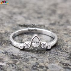 a white gold ring with three pear shaped diamonds