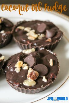 there are chocolates with nuts in the middle on a white plate and text overlay that says coconut oil fudge