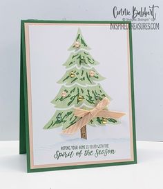 a handmade christmas card with a pine tree on the front and words underneath it