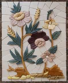 this is a tile with flowers and leaves on it