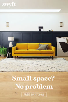 a yellow couch sitting on top of a hard wood floor next to a white rug