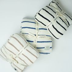 three striped towels are stacked on top of each other