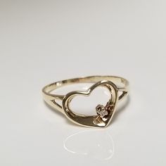 Thanks for shopping our vintage estate store. We tend to sell well below wholesale and truly hope you enjoy all of our items. Many of the items are one of a kind, so please enjoy scrolling through the pictures and hopefully something will catch your eye. Brown spots are from camera. Estate 10k yellow gold .01ct diamond heart ring.  Ring size: 6.75 Diamond: .01ct Setting: 10mm 3/8" Band width: 2mm Weight: 1.19 grams Very sweet ring. Marked 10k. 1 small diamond in setting. Daughter Ring, Diamond Gold Ring, Sweet Ring, Diamond Heart Ring, Heart Diamond, Diamond Gold, Gold Diamond Rings, Ring Ring, Diamond Heart