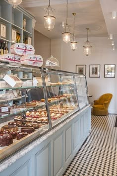 a bakery filled with lots of different types of cakes and pastries on display in front of the counter