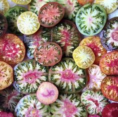 many different colored slices of fruit are arranged in the shape of an abstract flower pattern