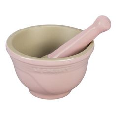 a pink bowl with a spoon in it