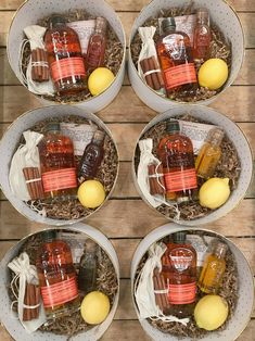 four bowls filled with different types of condiments on top of a wooden table