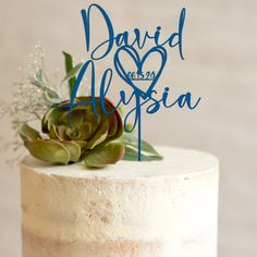 a wedding cake with a succulent topper and the words david and alisia on it