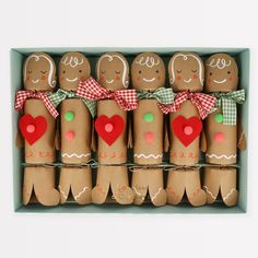 a box filled with lots of gingerbreads in different shapes and sizes sitting on top of each other