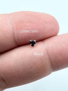 a tiny black diamond is shown in the palm of someone's hand