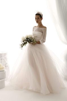 a woman in a wedding dress holding a bouquet