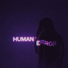 a person standing in the dark with their back turned to the camera and text that reads human error