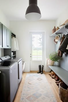 a kitchen area with a rug, sink and stove top oven next to a door