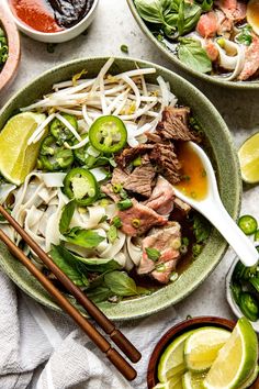 two bowls filled with meat and vegetables next to chopsticks