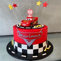 a birthday cake for a two year old boy with cars and stars on the top