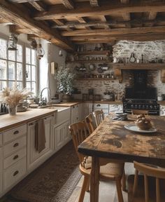 an old fashioned kitchen with wooden floors and white cupboards, wood ceilinging and exposed beams