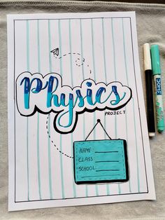 a piece of paper with the words physics written on it next to markers and pens