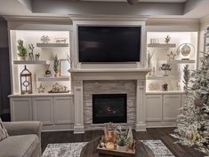 a living room filled with furniture and a flat screen tv mounted on the wall above a fireplace