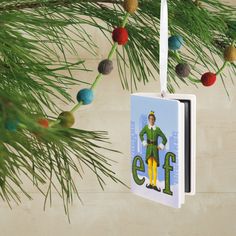 an ornament hanging from a christmas tree with the elf on it's back