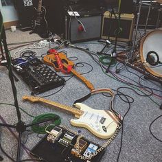 an assortment of musical instruments and amps on the floor