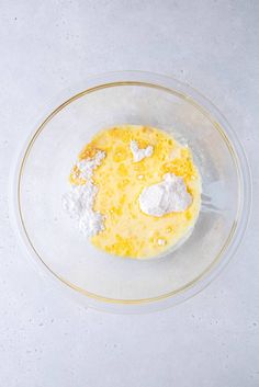 a bowl filled with eggs and flour on top of a table