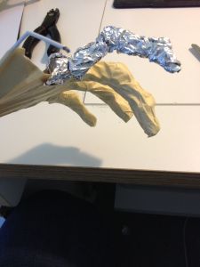 a piece of tin foil sitting on top of a table next to scissors and an umbrella