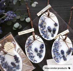 three plates with dried lavenders on them are sitting on a table next to some flowers