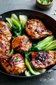 chicken and broccoli in a skillet on a table with chopsticks